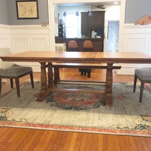Corinthian style table with cushioned chairs