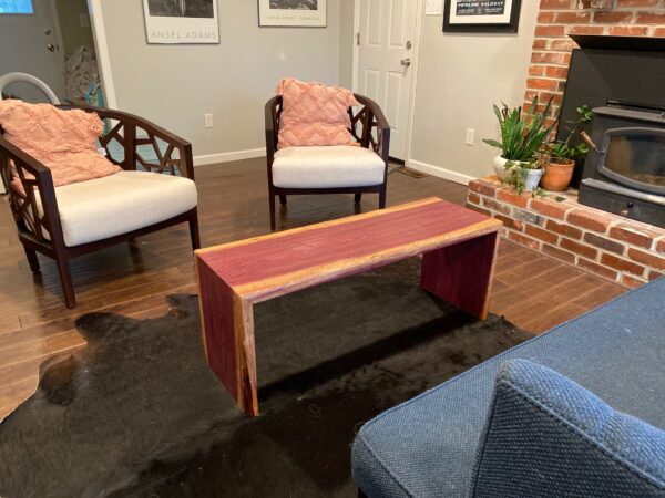 Red and tan coffee table that looks like a bench