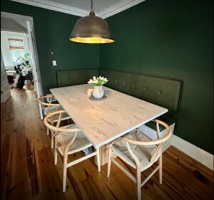 custom white dining table with green booth seats